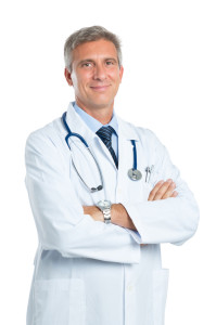 Portrait Of A Confident Mature Doctor Looking At Camera Isolated On White Background